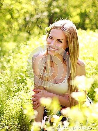 Sensual young woman, smiles sweetly in the flowered garden Stock Photo