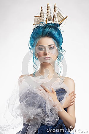 Sensual young girl with naked shoulders and painted blue hair st Stock Photo