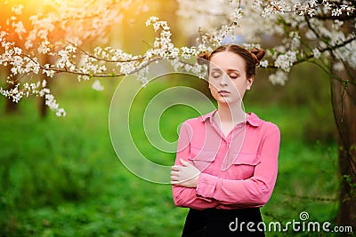 Sensuality. Happy beautiful young woman relaxing in blossom park Stock Photo