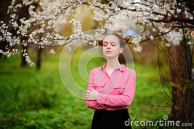 Sensuality. Happy beautiful young woman relaxing in blossom park Stock Photo