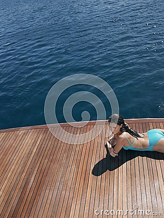 Sensuous Woman In Swimsuit Relaxing On Yacht Stock Photo