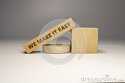 The sentence We make it easy was written. Wooden concept studio shoot Stock Photo