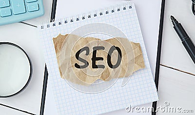 Seo Career. Opened Notebook With Seo-Optimization Scheme Lying Over Brown Office Table Background. Search Engine Optimization For Stock Photo