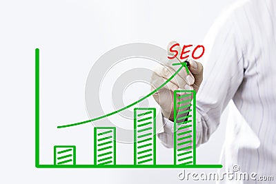 SEO text with hand of young businessman point on virtual graph Stock Photo