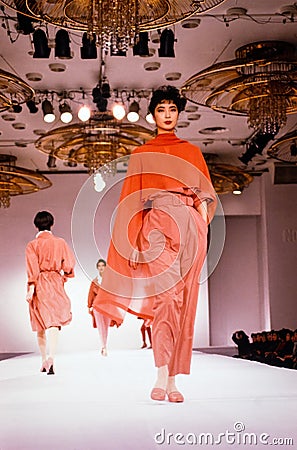 Seoul , Korea - SEPTEMBER 08 1989: A model walks the runway fashion show. Scanned from film transparency - visible grain. Editorial Stock Photo