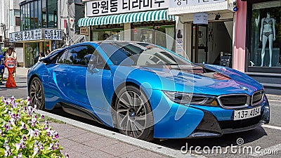 Blue car BMW i8 front view, stands by the glass wind of a shop in downtown Seoul Editorial Stock Photo