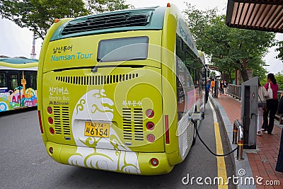 Seoul, South Korea - 1 June 2014, The green electric bus are recharging the power from the station between taking the tourist down Editorial Stock Photo
