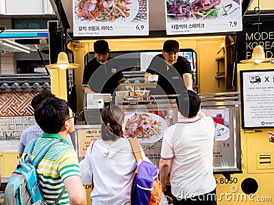 Seoul, South Korea - June 17, 2017: People queuing up at the fast food kiosk at the street near Cheonggyecheon stream in Seoul Editorial Stock Photo