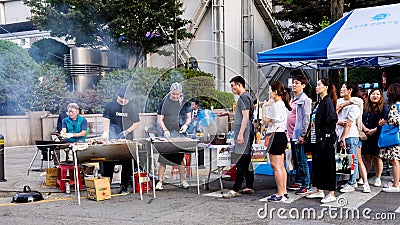 Seoul, South Korea - June 3, 2017: People queuing up at the fast food kiosk at the street near Cheonggyecheon stream in Seoul. Editorial Stock Photo