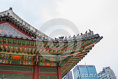 SEOUL / SOUTH KOREA - JUNE 24, 2013: Traditional temple with modern skyscraper in background - Historic culture and economic futur Editorial Stock Photo