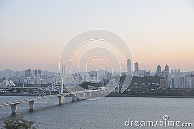 SEOUL, SOUTH KOREA - OCTOBER 24, 2022: Calm Sunset scene with bridge, buildings, and Han river in the afternoon and blue sky Editorial Stock Photo