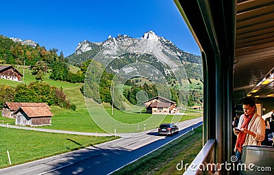 Swiss rural farmland peaceful scenery through train window with tourist Editorial Stock Photo