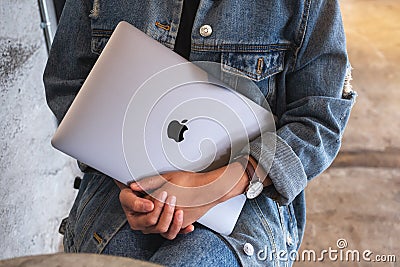 Sep 16th 2020 : A woman holding an Apple MacBook Pro laptop computer , Chiang mai Thailand Editorial Stock Photo