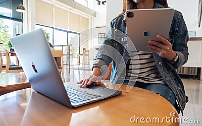 Sep 21th 2020 : A woman using Apple New Ipad Pro 2020 digital tablet with Apple MacBook Pro laptop computer on wooden Editorial Stock Photo