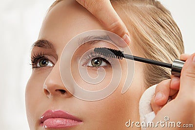 Separating and curling lashes with mascara brush Stock Photo