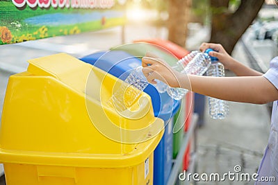 Separating waste plastic bottles into recycling bins is to protect the environment, causing no pollution, reduce global warming, Stock Photo