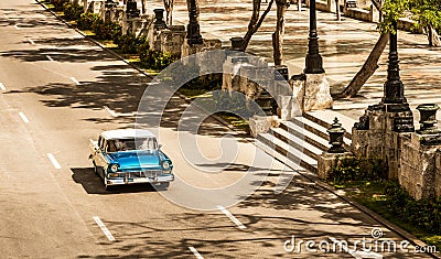 Sepia - American blue 1956 vintage car on the high angle view drives on the street Jose Marti in Havana City Cuba - Serie Cuba Editorial Stock Photo