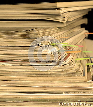Sepia-style photo of pile of old magazines with bookmarks Stock Photo