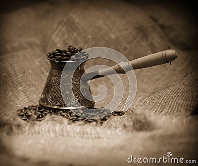 Sepia toned image of cezve with coffee Stock Photo