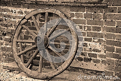 Sepia vintage iron gate in front of a mossy brick wall. Stock Photo