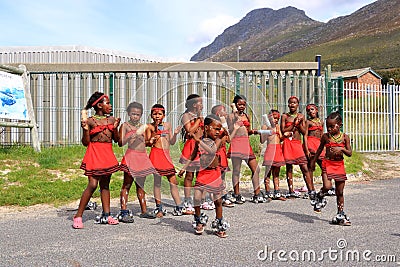 September 25 2022 - Boulders Beach penguin cottage, Cape Town, South Africa: traditionally dressed dancing girls greet the guests Editorial Stock Photo