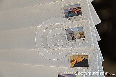 9 september 2021 - Calgary Alberta Canada - Canada Postage stamps on envelopes for mail Editorial Stock Photo