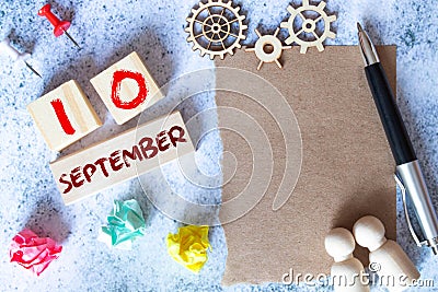 September 10 - Daily colorful Calendar with Block Notes and Pencil on wood table background Stock Photo