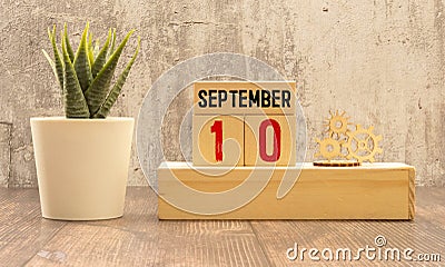 September 10 - Daily colorful Calendar with Block Notes and Pencil on wood table background Stock Photo