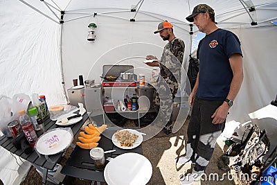 DUBIOUS WYOMING: Two hunters in camp making breakfast in a tent Editorial Stock Photo