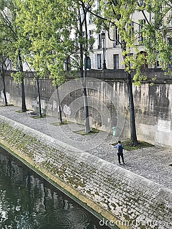 Fisherman catches tiny Seine fish, Paris Editorial Stock Photo