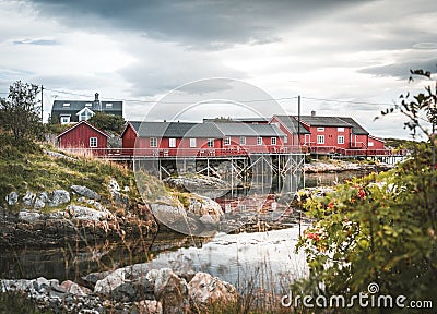September 2018, Henningsvaer Lofoten island. Red Rorbuer houses in the Henningsvaer fishing village on a cloudy day. The Editorial Stock Photo