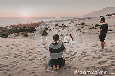 professional photographer and videographer organizing outdoor wedding photo shooting. Bride Editorial Stock Photo