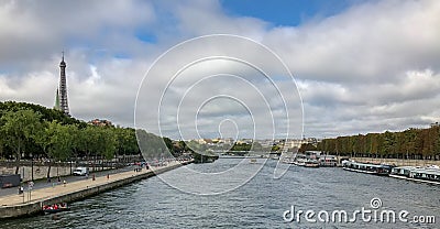 The Seine on a September Sunday, crowds and Eiffel Tower in back Editorial Stock Photo