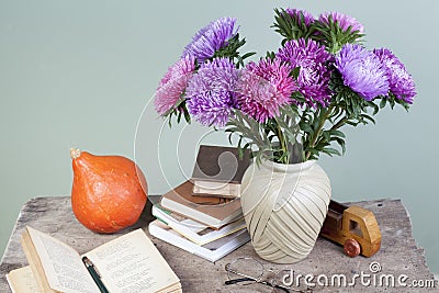 September 1 still life a bouquet of asters and books on the background of a school board Stock Photo