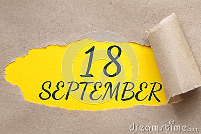 september 18. 18th day of the month, calendar date.Hole in paper with edges torn off. Yellow background is visible Stock Photo