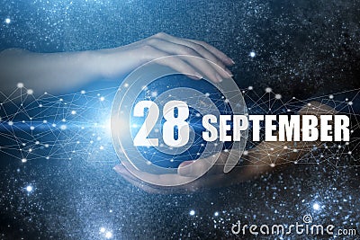 September 28th. Day 28 of month, Calendar date. Human holding in hands earth globe planet with calendar day. Elements of this Stock Photo