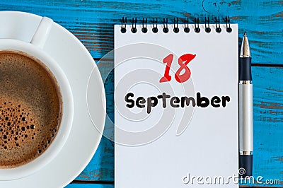 September 18th. Day 18 of month, morning cappuccino cup with loose-leaf calendar on analyst workplace background. Autumn Stock Photo
