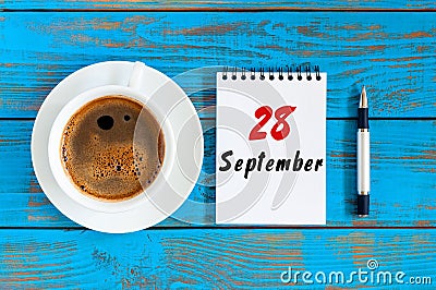 September 28th. Day 28 of month, morning coffee cup with loose-leaf calendar on financial adviser workplace background Stock Photo