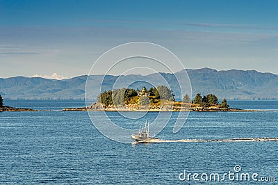 September 17, 2018 - Tongass Narrows, AK: Aluminum fishing boat near Guard Islands and lighthouse, early morning. Editorial Stock Photo