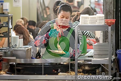 AN - SEPTEMBER 20: Unnamed busy food vendor prepares order for customers at dinner time in Taipei on September 20, 2020 Editorial Stock Photo