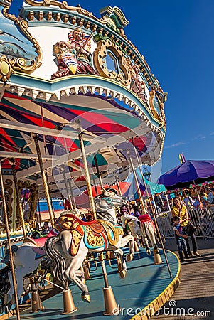 September 2, 2012 - Vancouver, Canada: Colourful vintage carousel horse ride at annual PNE Fair, late afternoon. Editorial Stock Photo