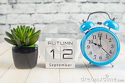 September 12 on the wooden calendar.The twelfth day of the autumn month, a calendar for the workplace. Autumn Stock Photo