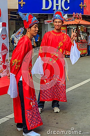 Unidentified people in traditional outfits a busy shopping stree Editorial Stock Photo
