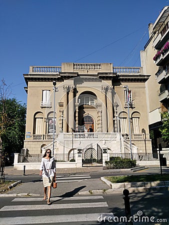 15.08.2018. Serbia. Belgrade. Nikola Tesla museum and beautiful women walking on the street in front of the museum Editorial Stock Photo