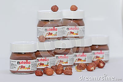 Serbia; Kragujevac; November 4, 2018; Small nutella jars stacked on top of one another with hazelnuts isolated on white Editorial Stock Photo