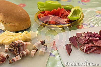 Serbian breakfast with sliced domestic sausage, bacon, ham and cheese. Stock Photo