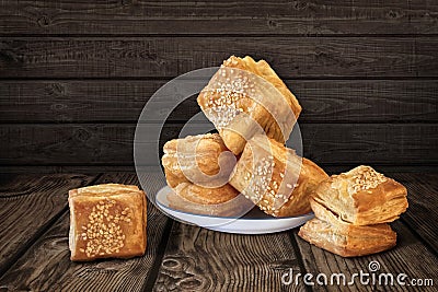 Bunch Of Freshly Baked Small Square Sesame Puff Pastry Zu-Zu Set On Rustic Knotted Wood Background Stock Photo