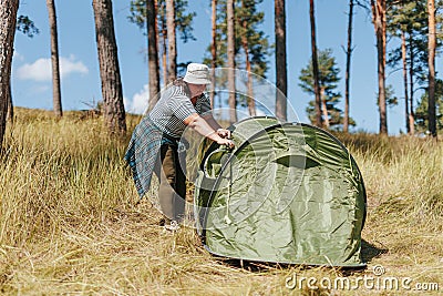 Setting Up Serenity Plus Size Woman Creates Tranquil Campsite, Arranging the Tent Stock Photo