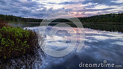 Serene lake reflection with purple sky Stock Photo
