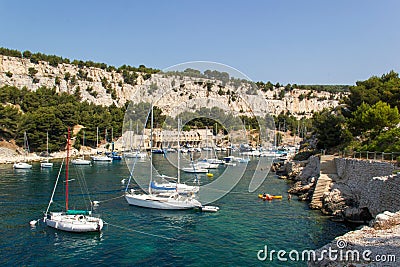 Serene scene of several sailboats docked at a tranquil harbor in Cassis, France. Stock Photo